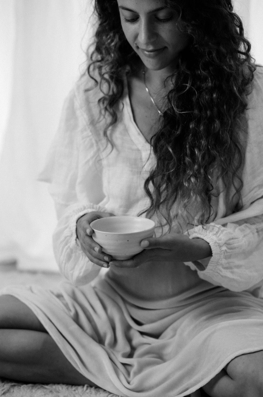 woman holds tea cup in ceremony