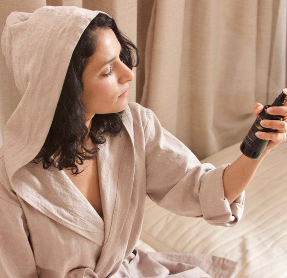 person in a robe uses mist with Shemana logo