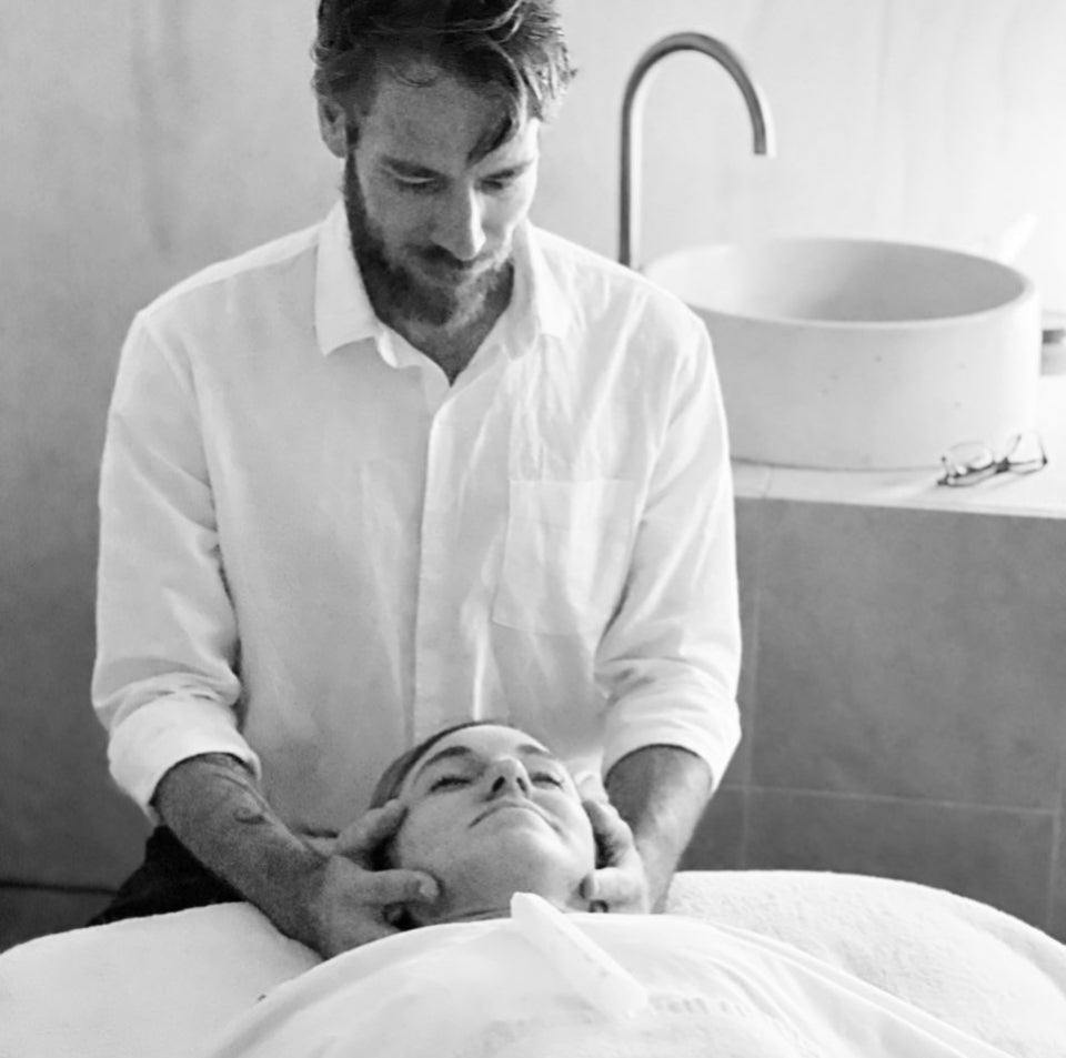 man uses cranio sacral on a womans head