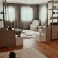 House of shemana treatment space white chair shelves windows and rug