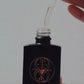 oil perfume with coding in black glass bottle 