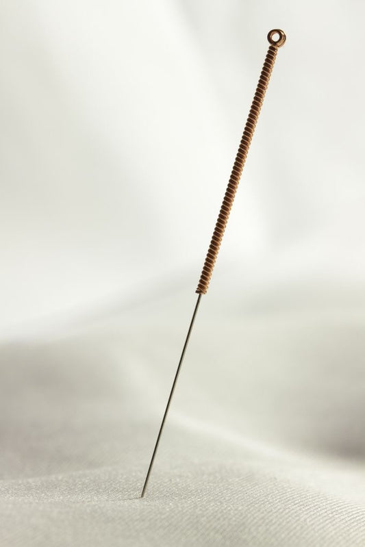 acupuncture needle on a white sheet